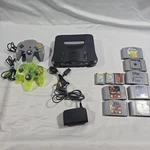 Nintendo N64 Black Console Bundle With 2 Controllers 7 Games 3 Memory Cards Used. Price: $179.99.