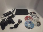 Sony Playstation 2 Slim SCPH-70001 Ntsc-u/c Bundle W/ Controller, Cables, Games Used. Price: $130.00.