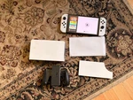 Nintendo Switch Oled Console With Zelda Case + Screen Protectors Used. Price: $330.00.