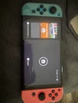 Nintendo Switch Oled Model W/ Neon Red & Blue Joy-con Used. Price: $215.00.