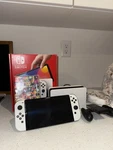 Nintendo Switch Oled Model 64GB - White With 128 And Mario Kart Deluxe Open. Price: $250.00.