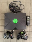 Original Microsoft Xbox Video Game Console + 2 Controllers And Remote Used. Price: $139.99.