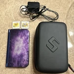 Nintendo New 3DS Xl Purple Galaxy 4GB Ntsc-u/c W/ Charger, Case, And 2 Games Used. Price: $317.50.