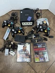 Nintendo Gamecube 4 Oem Controllers, 2 Games, Memory Cards & Microphone Used. Price: $195.00.