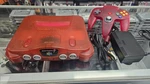 Funtastic Watermelon Red Nintendo N64 Console With Controllers And Games Used. Price: $250.00.
