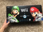 Nintendo Original Wii Mario Kart Bundle Black Console With Wheel Sealed Game Used. Price: $249.99.