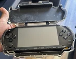 Sony PSP-1000 Black Handheld System With Headphone Jack & Protective Case Used. Price: $125.00.