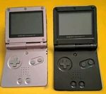 Two Nintendo Gameboy Advance Sp Pearl Pink And Black Used. Price: $285.00.
