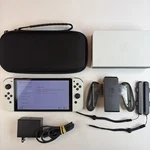 Nintendo Switch Oled Model HEG-001 Handheld Console White Joycons Dock Used. Price: $209.00.