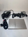 Sony Playstation 2 Slim Silver (SCPH-79001) Bundle With Controller And Cords Used. Price: $109.99.