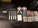 Nintendo Wii Console With 4 Remotes & 8 Games Used. Price: $127.31.