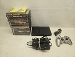 Sony SCPH-75001 PS2 Slim With 25 Games Used. Price: $199.99.