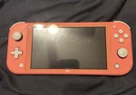 Nintendo Switch Lite Coral + Carrying Case Used. Price: $120.00.