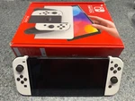 Nintendo Switch Oled Handheld Console 64GB Model: HEG-001 With White Joycons Used. Price: $189.99.